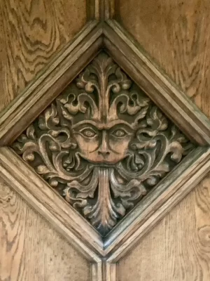 The Narnia Door as part of the Inklings private walking tour of Oxford with Chris Peters. This has a face carved into the wood of the door.